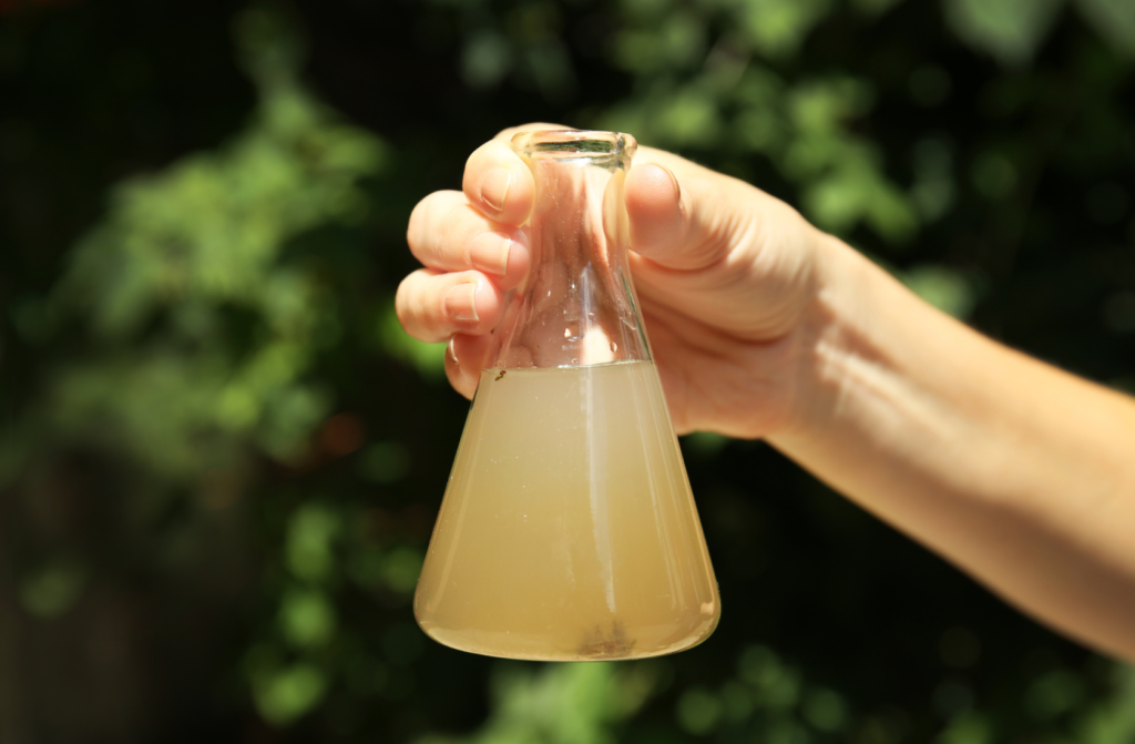 a conical flask filled with dirty water