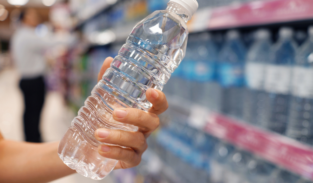 picking up bottled water from supermarket shelves