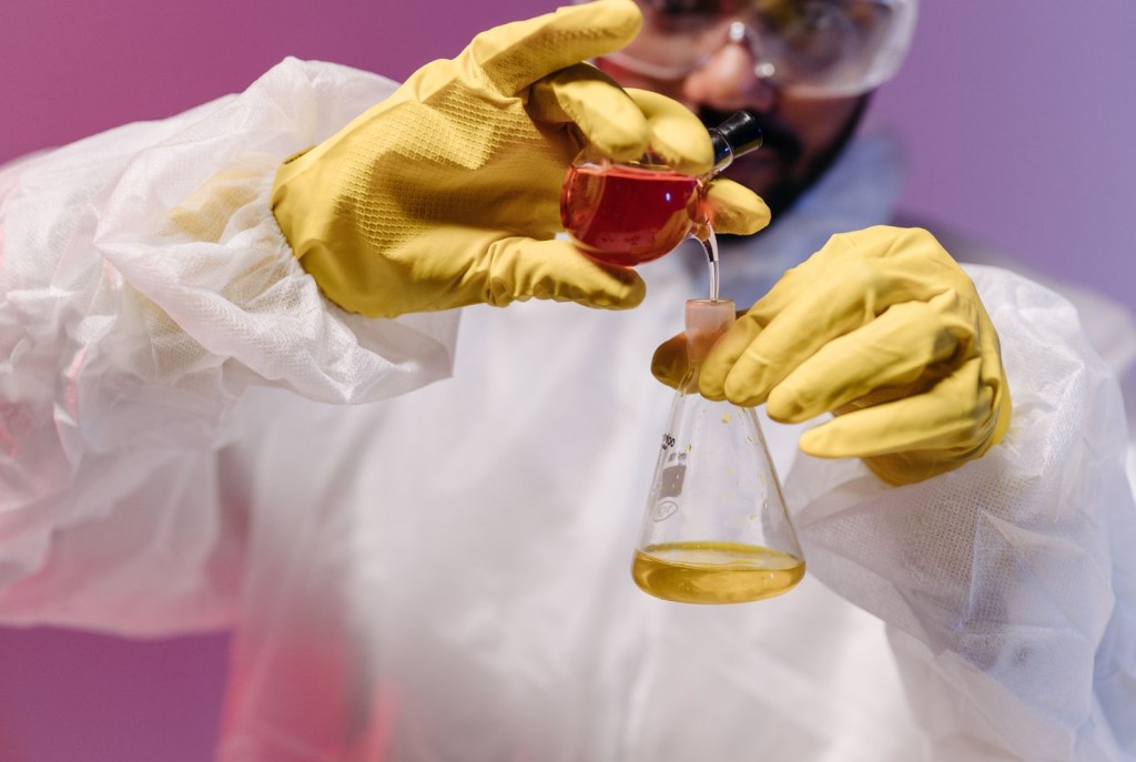 an experimenter holding two test tubes